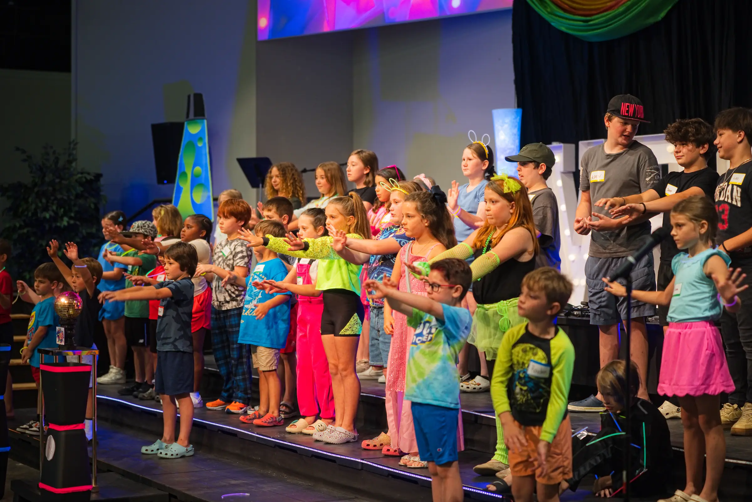 Kids worshipping together on stage at Addis Kidz