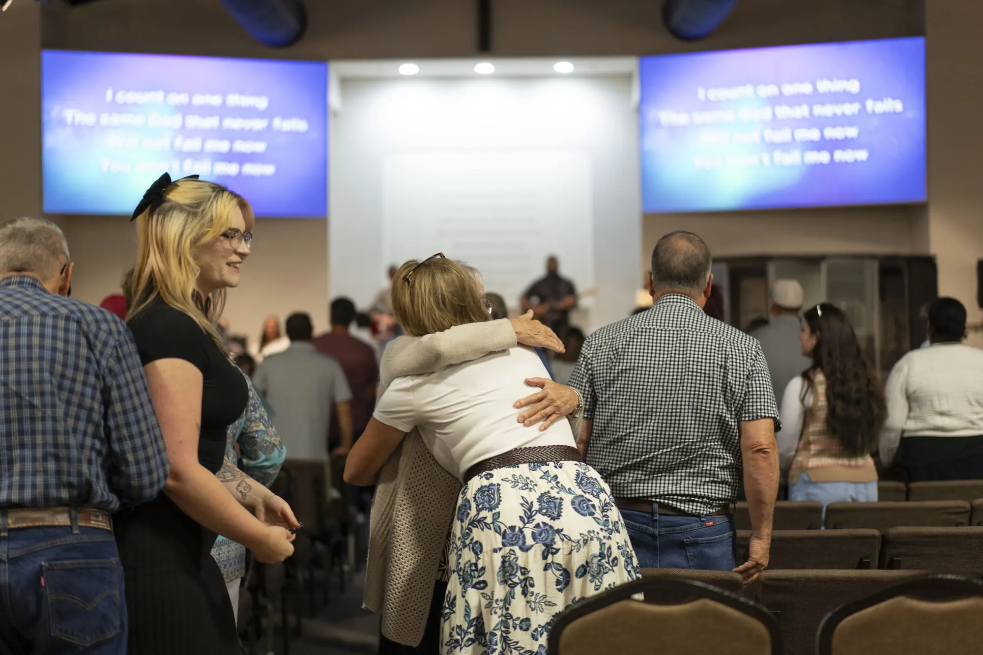 Church members embracing after a Sunday service
